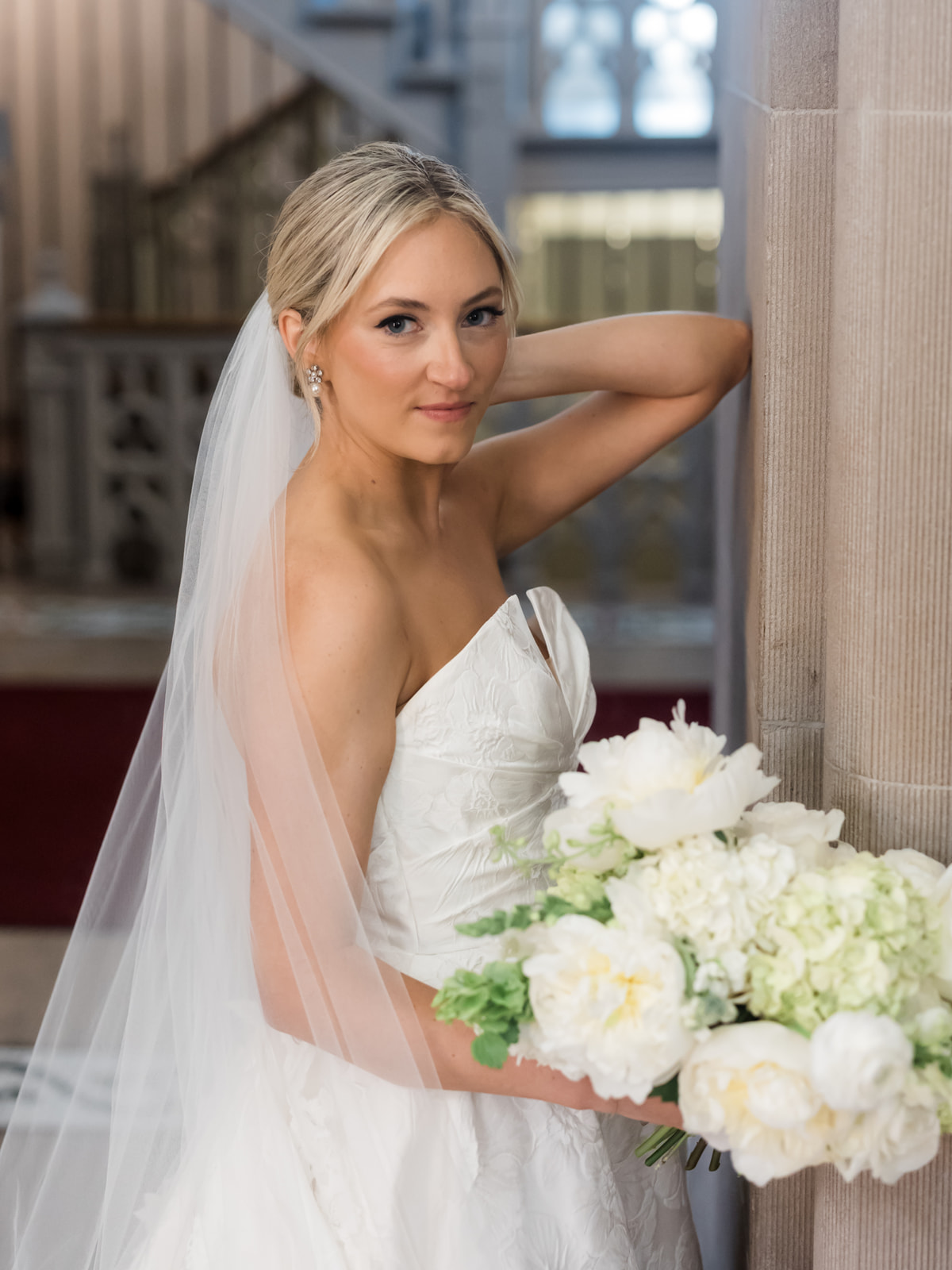 Bride Maddie holding a white and green garden-inspired bridal bouquet at her Pittsburgh wedding at St. Paul's Cathedral and Fox Chapel Golf Club.