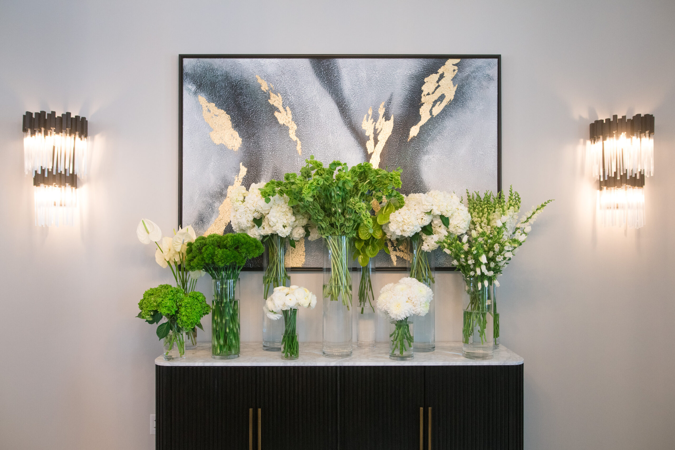Green and white flowers on a modern hotel lobby credenza