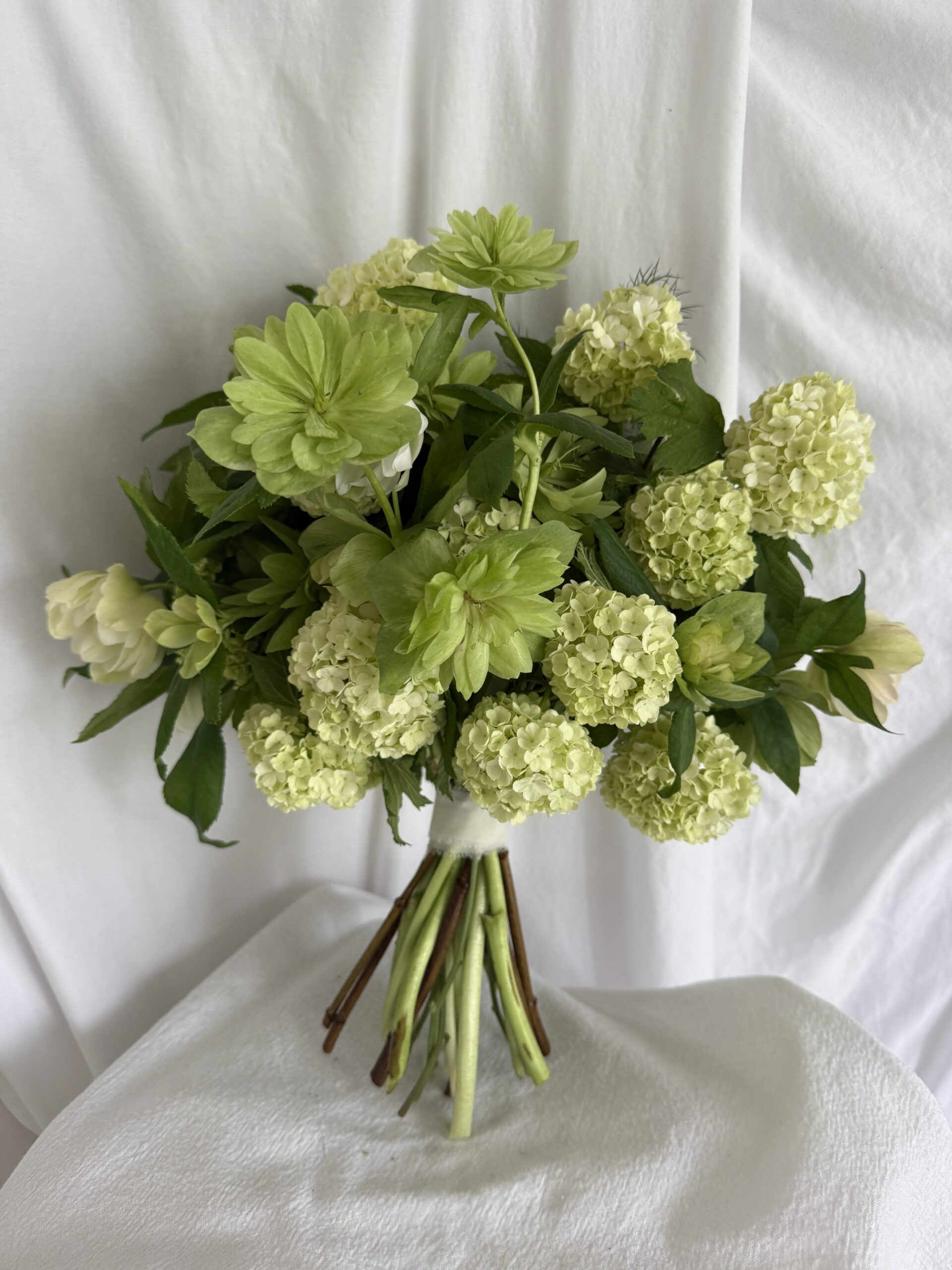 This white and green bride's bouquet was constructed entirely of garden-grown blooms. Pittsburgh, PA in April