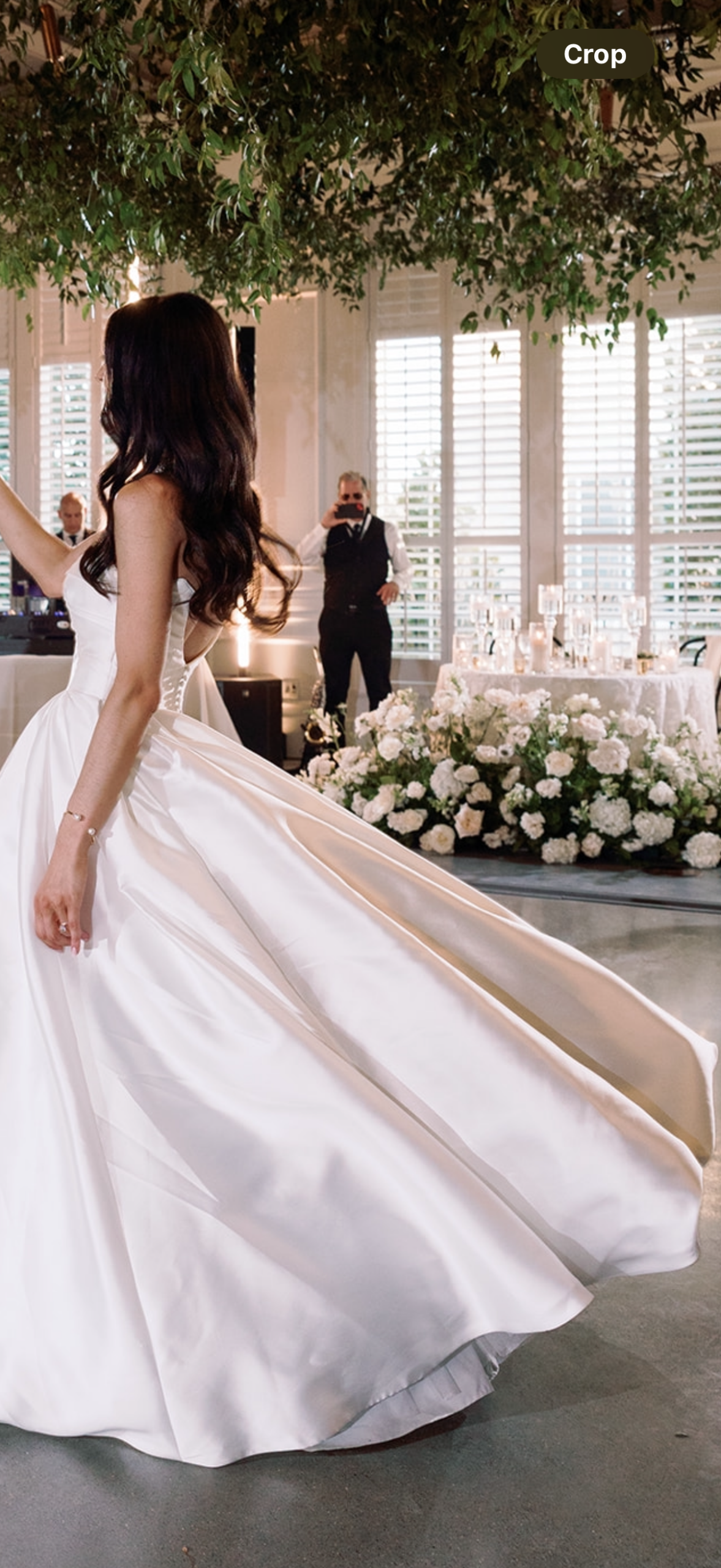 Bride dancing beside repurposed floral ceremony arch installation and hanging greenery at The Audrey Pittsburgh wedding